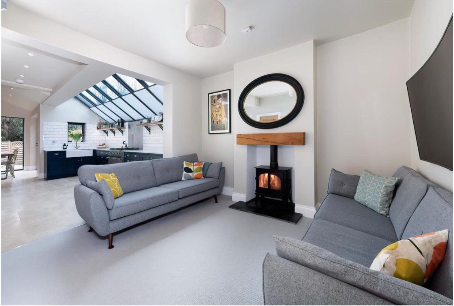 Open-plan living with log burner and lantern roof