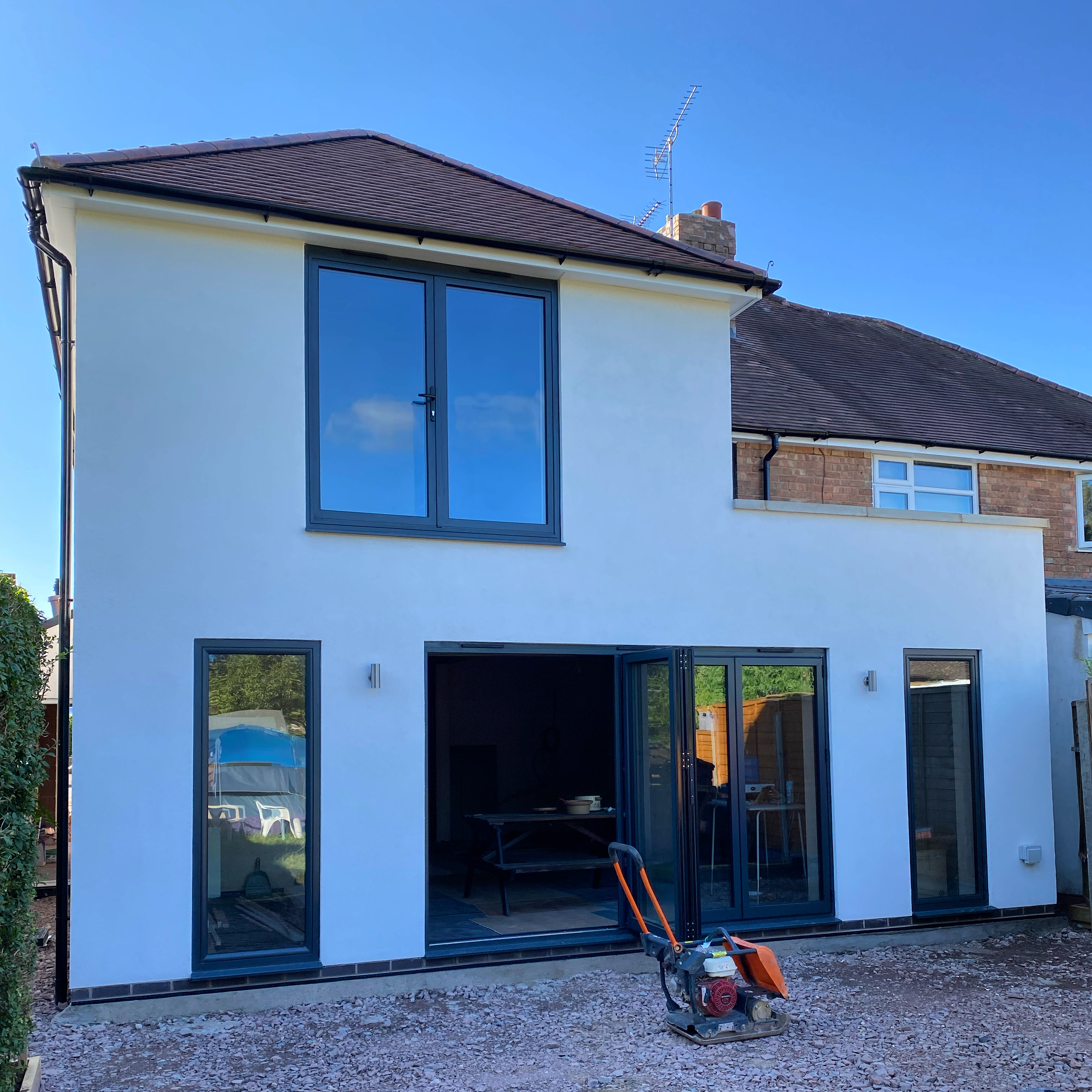 Completed two-storey extension with render finish